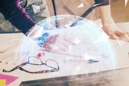 Double exposure of Man writing in notepad with business icons on background.の写真素材