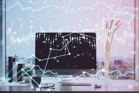 Stock market graph on background with desk and personal computer. Multi exposure. Concept of financial analysis.の写真素材