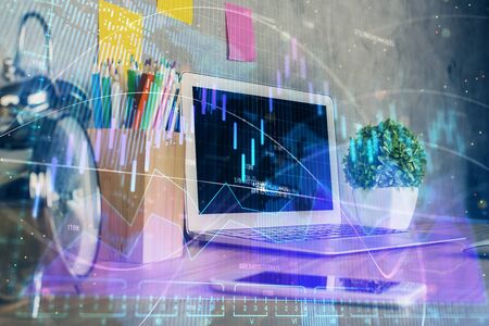 Financial graph colorful drawing and table with computer on background. Multi exposure. Concept of...