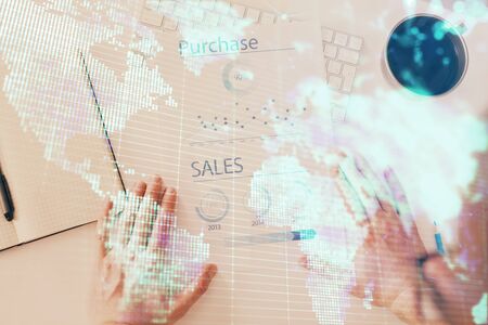 Double exposure of hands and notepad with business icons.の写真素材