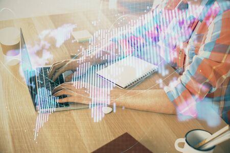 Multi exposure of businessman working on laptop on background. International business hologram in front. Concept of success.の写真素材