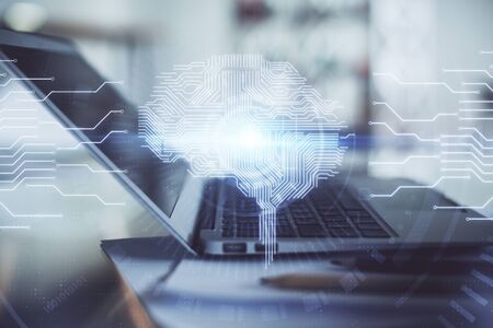 Double exposure of desktop with computer and brain drawing hologram. Artificial intelligence...
