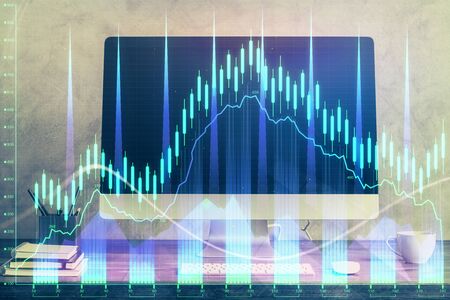 Financial market graph hologram and personal computer on background. Double exposure. Concept of forex.の写真素材