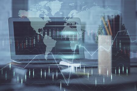 Double exposure of chart and financial info and work space with computer background. Concept of international online trading.の写真素材