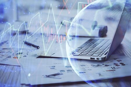 Stock market graph and table with computer background. Multi exposure. Concept of financial analysis.の写真素材
