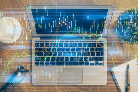 Double exposure of forex graph and work space with computer. Concept of international online...