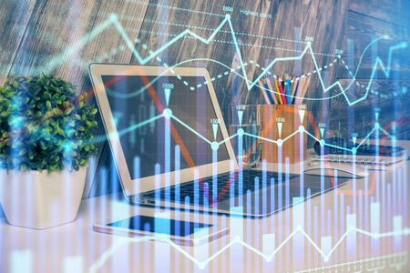 Double exposure of chart and financial info and work space with computer background. Concept of...