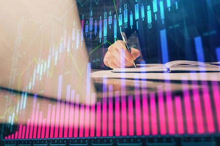 Double exposure of businessman with laptop and stock market forex chart.