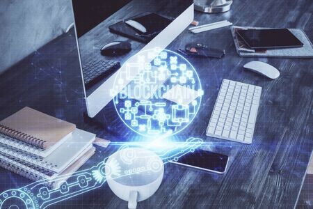 Double exposure of blockchain and crypto economy theme hologram and table with computer background....