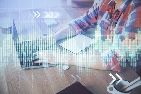 Multi exposure of forex graph with man working on computer on background. Concept of market analysis.の写真素材