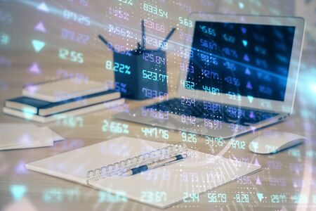 Financial market graph hologram and personal computer on background. Multi exposure. Concept of forex.の写真素材