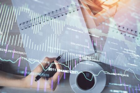 Multi exposure of womans hands making notes with forex graph hologram. Concept of technical analysis.の写真素材