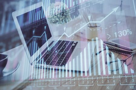 Stock market graph and table with computer background. Multi exposure. Concept of financial analysis.の写真素材