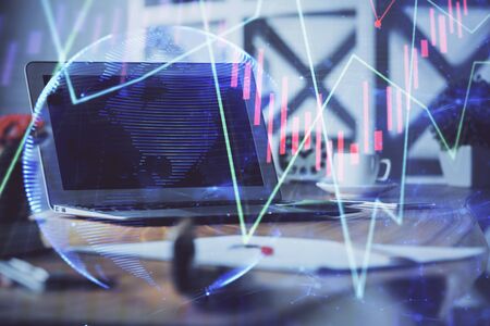 Forex market chart hologram and personal computer background. Multi exposure. Concept of investment.の写真素材