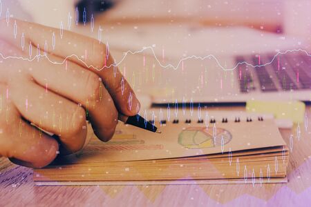 Multi exposure closeup hands with stock market forex graph.の写真素材