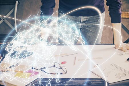 Double exposure of Man writing in notepad with business icons on background.の写真素材