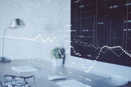 Forex graph hologram on table with computer background. Multi exposure. Concept of financial...
