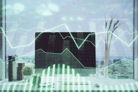 Forex Chart hologram on table with computer background. Multi exposure. Concept of financial markets.の写真素材