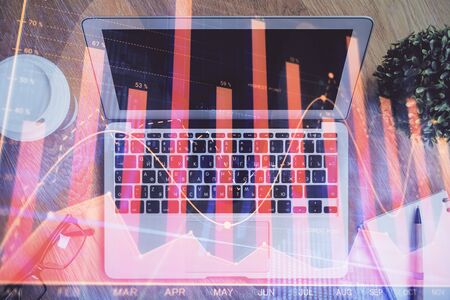 Double exposure of forex chart and work space with computer. Concept of international online trading.の写真素材