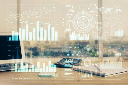 Forex market graph hologram and personal computer on background. Double exposure. Concept of...