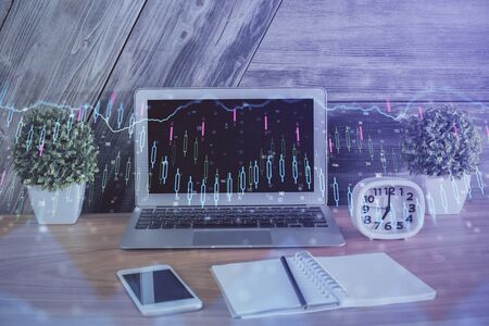 Double exposure of chart and financial info and work space with computer background. Concept of international online trading.の写真素材