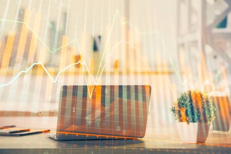 Stock market graph and table with computer background. Double exposure. Concept of financial analysis.の写真素材