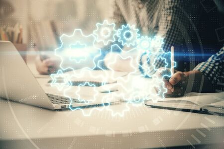 Multi exposure of businessman working on laptop on background. International business hologram in...