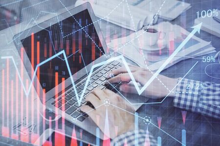 Double exposure of forex chart with man working on computer on background. Concept of market...