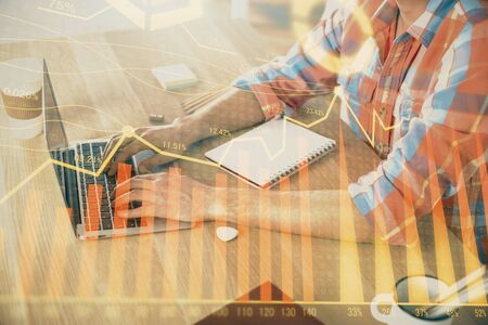Multi exposure of forex graph with man working on computer on background. Concept of market analysis.の写真素材