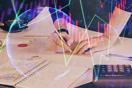 Double exposure of man writing on paper with forex graph.の写真素材