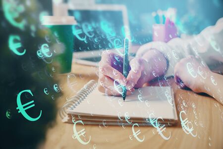 Forex chart displayed on womans hand taking notes background. Concept of research. Double exposureの写真素材