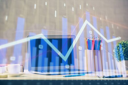 Stock market graph and table with computer background. Multi exposure. Concept of financial analysis.の写真素材