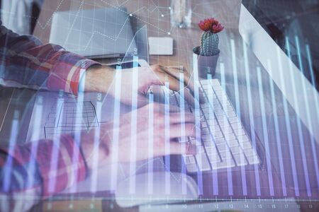 Double exposure of stock market chart with man working on computer on background. Concept of financial analysis.の写真素材