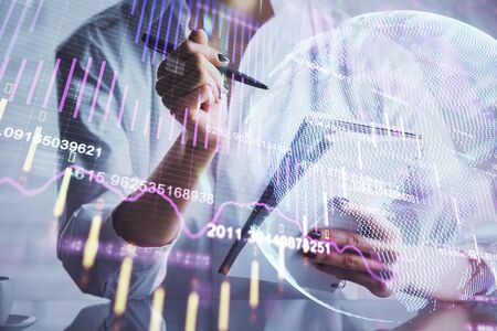 Financial chart drawn over hands taking notes background. Concept of research. Multi exposure