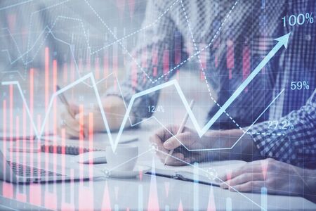 Multi exposure of forex chart with man working on computer on background. Concept of market...