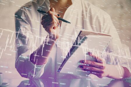 Financial chart drawn over hands taking notes background. Concept of research. Multi exposure