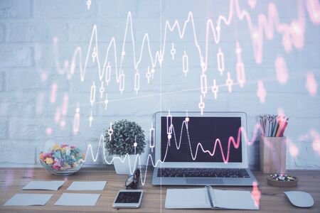 Forex market chart hologram and personal computer background. Multi exposure. Concept of investment.の写真素材