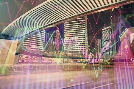 Forex chart on cityscape with tall buildings background multi exposure. Financial research concept.の写真素材