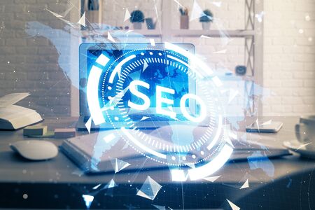 Multi exposure of table with computer and seo drawing hologram. Search optimization concept.の写真素材