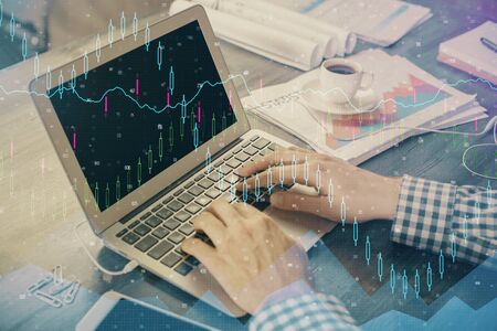 Double exposure of forex graph with man working on computer on background. Concept of market...