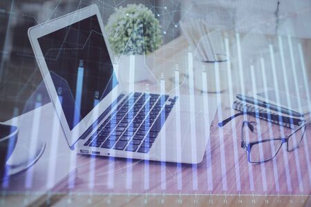 Forex Chart hologram on table with computer background. Double exposure. Concept of financial markets.の写真素材