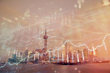 Forex chart on cityscape with tall buildings background multi exposure. Financial research concept.の写真素材