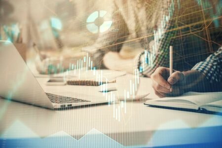 Multi exposure of forex chart with man working on computer on background. Concept of market...