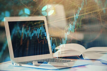 Forex graph hologram on table with computer background. Double exposure. Concept of financial...