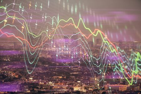 Financial graph on night city scape with tall buildings background double exposure. Analysis concept.の写真素材