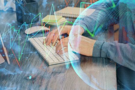 Stock graph with businessman typing on computer in office on background. Concept of analysis. Double exposure.の写真素材