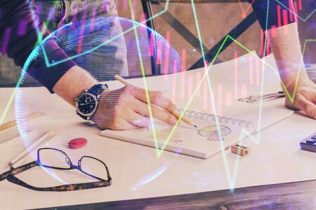 Multi exposure of man hands with stock market forex graph.の写真素材