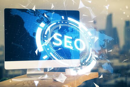 Multi exposure of table with computer and seo drawing hologram. Search optimization concept.の写真素材