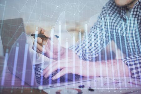 Double exposure of forex graph with man working on computer on background. Concept of market analysis.の写真素材