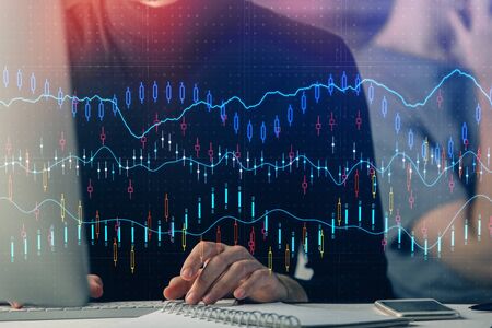 Forex graph with businessman typing on computer in office on background. Concept of analysis. Double...
